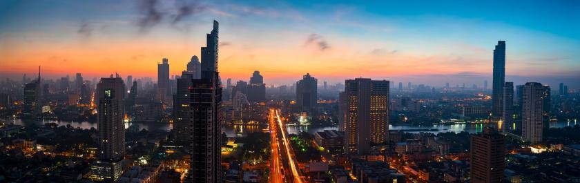 Scenic of panorama view of sunrise skyline and cityscape with light tail on road into metropolis, Bangkok, Thailand